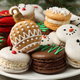 Holiday macaron cookies shaped like snowmen and ornaments